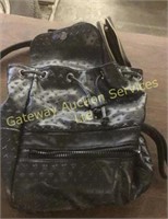Back pack style Versace purse with fossil wallet.
