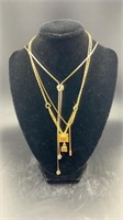 Three gold colored necklaces