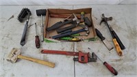Assortment of various tools: pipe wrench,