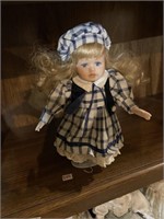 smaller porcelain doll checkered outfit