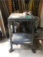 corner of garage with metal stand, roof rake, more