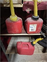 THREE GAS CANS .