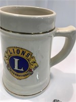 21 Collectors spoons in lions mug