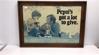 Framed Pepsi advertising poster in frame.