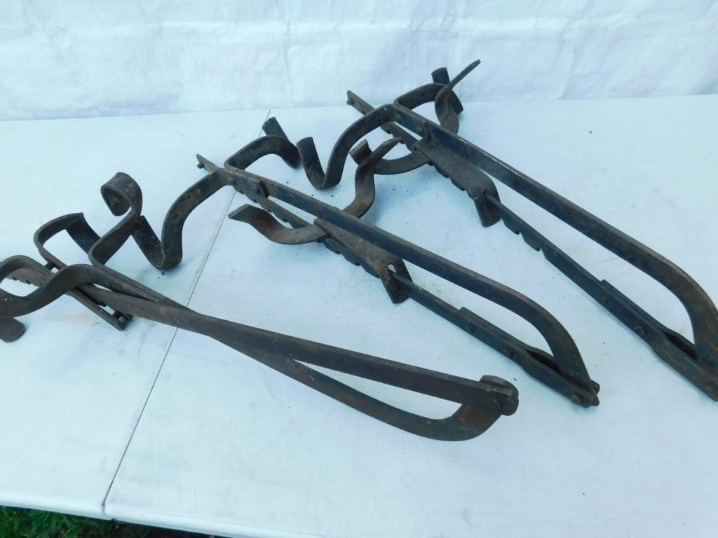 Three vintage ladder scaffold jacks.