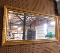 Beveled wall mirror in ornate frame, 44.5" x 23"