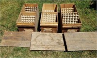 3 old wooden egg crates with the flats inside