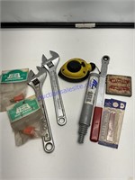 Two adjustable wrenches, chalk line sawblades