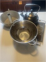 Colander, angel food cake pan, tea pot, food