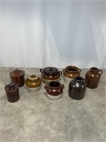 Pottery containers and jugs, some have lids.