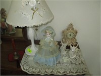 Lamp, old doll, clock and items on wall