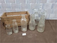 Apple wood crate and antique milk bottles