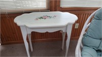 Wooden side table with coral painting on top.
