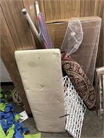 lot of ironing boards, rug, plastic shelf, bench