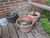 Plastic and terra cotta flower pots in corner