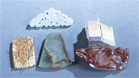 4 Jade and hardstone pendants and brooches.