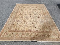 Cream Oriental style rug wool rug.  Has stain on