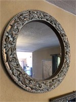 Round wall mirror in cast frame