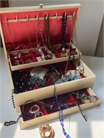 Cream colored jewelry box with jewelry
