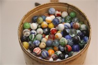 tin canister with hundred's of glass marbles