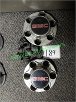 Two GMC Hubcaps