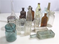 Assorted antique and vintage bottles and jars.