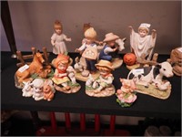 11 figurines, all depicting children and animals,