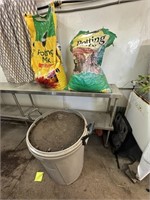 trash can full of dirt and potting soil