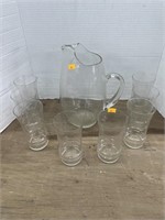 Clear glass pitcher and drinking glasses