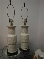 Pair of white china column lamps embossed