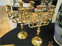 Pair of brass three-light candlesticks depicting
