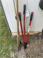 Group of hand tools, pruner, hoes, rake
