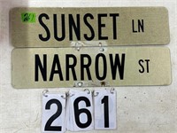 Street signs Sunset and Narrow