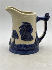Blue and cream stoneware pitcher with native