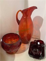 Orange crackle glass water pitcher, a red glass