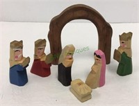 Miniature carved wooden nativity scene includes