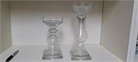 2 glass candle holders approximately 8" and 11"