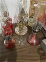 3 oil lamps and a chimney