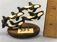 2 1/2" x 3" ivory carving of 4 whales mounted on a