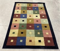 (AB) 
Color Block Pattern Area Rug. 
There is