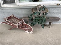 Wooden bench and wheelbarrow with birdhouse