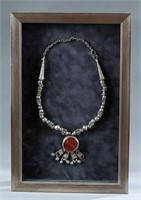 Framed North African silver necklace.