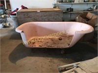 Old pink porcelain bath tub w/ cut-out