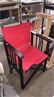 Black wood directors chair with a red cloth seat