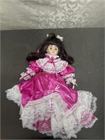 Porcelain doll in pink dress