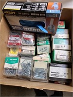 Box of assorted screws individually packaged still