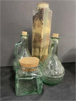 Two green glass vinegar decanters, a square glass
