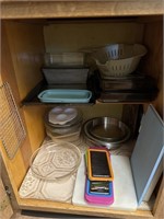 Cupboard full of casserole pans baking sheets pie