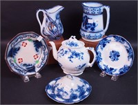 Six pieces of flow blue china: two cream pitchers,