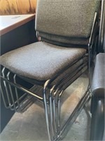 four stackable grey fabric chairs no arms
